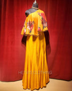 Yellow printed one shoulder cape and flared pants