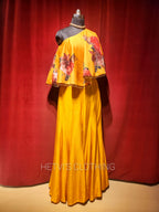 Yellow printed one shoulder cape and flared pants