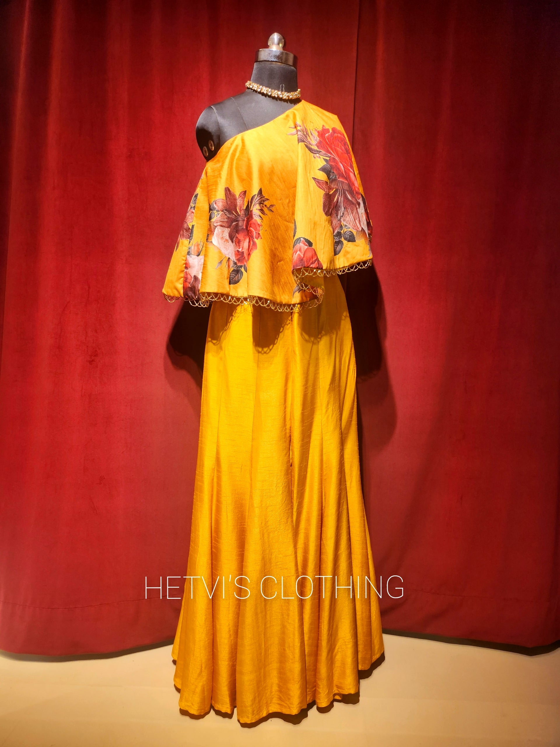 Yellow printed one shoulder cape and flared pants
