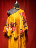 Yellow printed one shoulder cape and flared pants