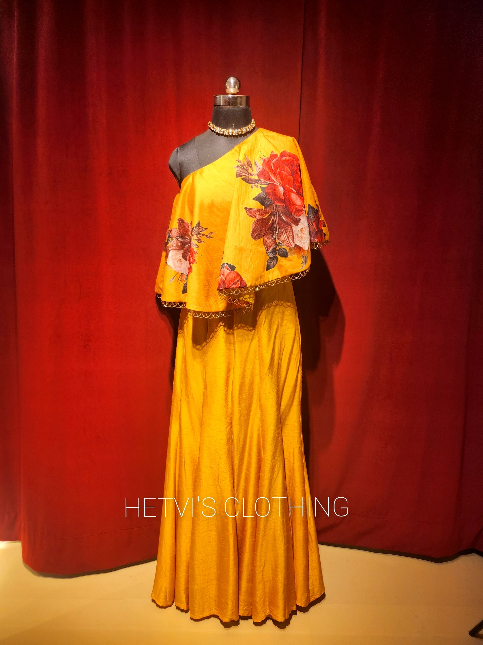 Yellow printed one shoulder cape and flared pants